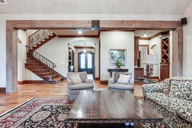 living room featuring hardwood / wood-style floors and beam ceiling