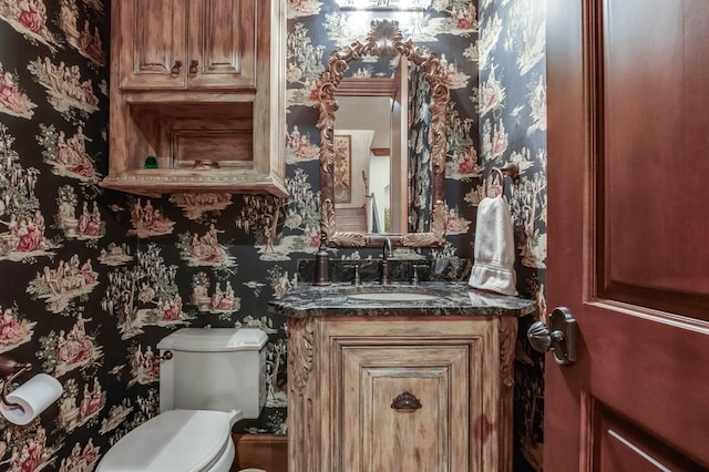 bathroom featuring vanity and toilet