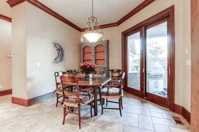 dining space featuring crown molding