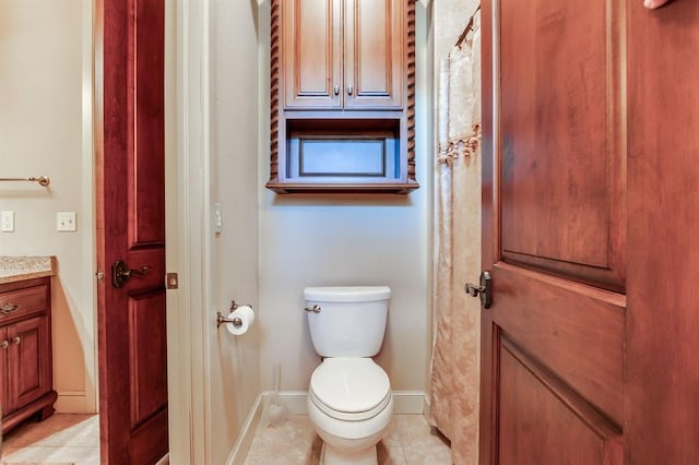 bathroom with tile patterned floors, vanity, and toilet