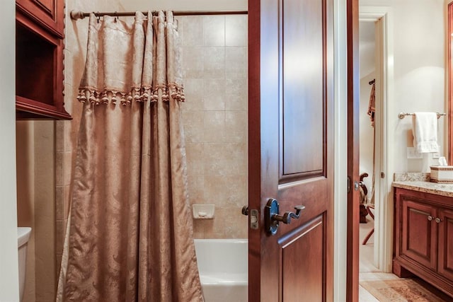 full bathroom featuring vanity, shower / bath combo, and toilet