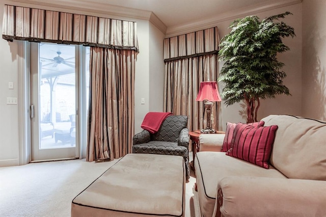 sitting room featuring crown molding, ceiling fan, and carpet floors