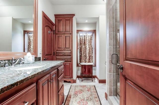 bathroom featuring walk in shower, tile patterned floors, and vanity