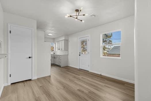 interior space featuring a notable chandelier and light wood-type flooring