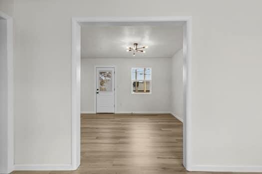 unfurnished dining area featuring wood-type flooring