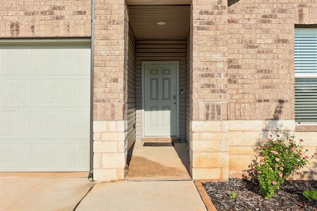 view of exterior entry with a garage