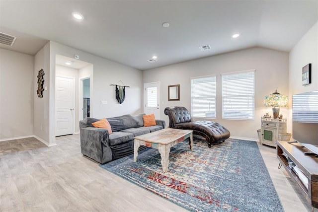 living room featuring vaulted ceiling and light wood-type flooring