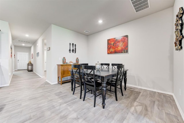 dining space with light hardwood / wood-style flooring