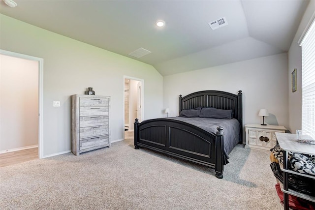 bedroom featuring lofted ceiling and light carpet