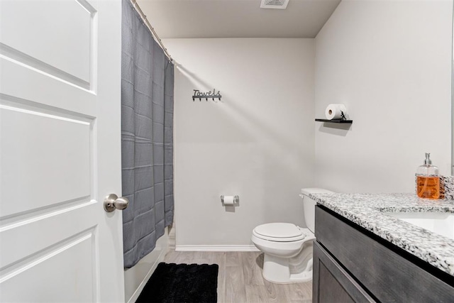 bathroom featuring vanity, hardwood / wood-style floors, toilet, and a shower with shower curtain