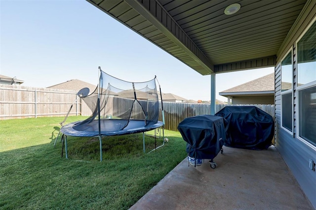 view of yard featuring a patio and a trampoline