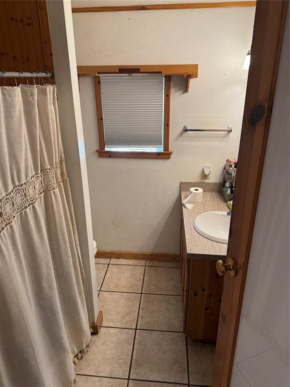 bathroom featuring baseboards, toilet, tile patterned floors, curtained shower, and vanity