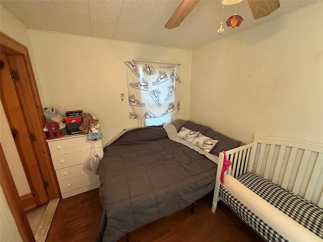 bedroom with a ceiling fan and wood finished floors