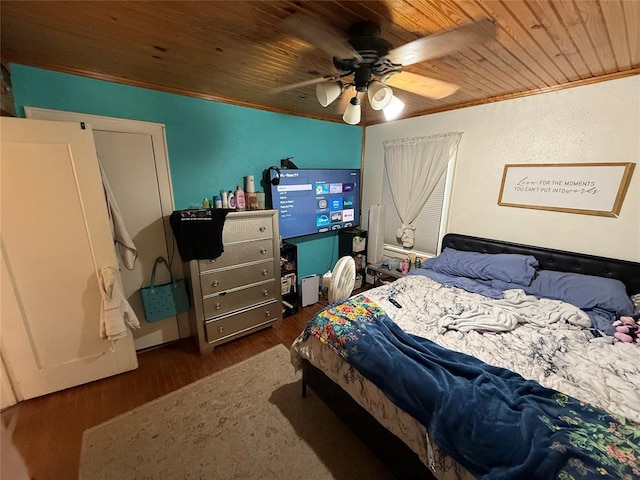 bedroom with a ceiling fan, wood ceiling, crown molding, and wood finished floors