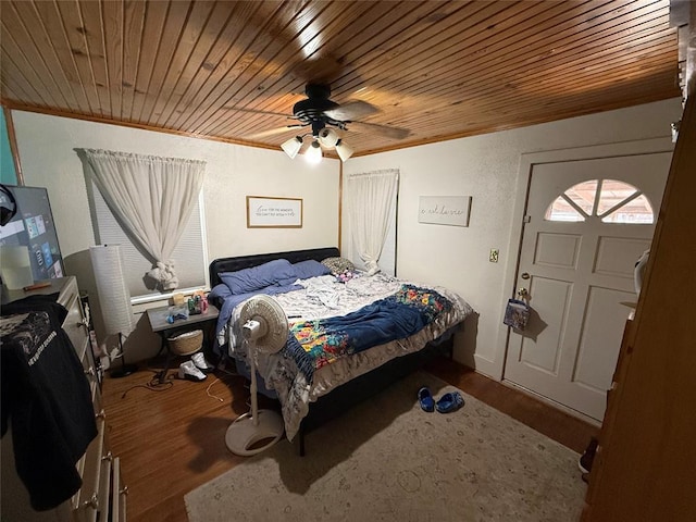 bedroom featuring wooden ceiling, ornamental molding, and wood finished floors