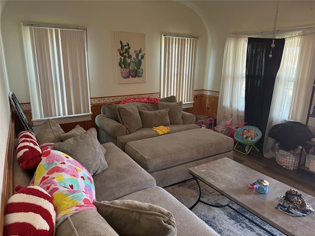 living room with wood finished floors and wainscoting