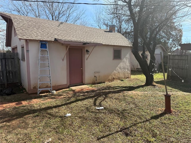 exterior space featuring an outbuilding and fence