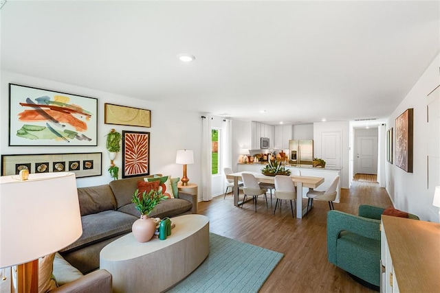 living room with dark hardwood / wood-style flooring