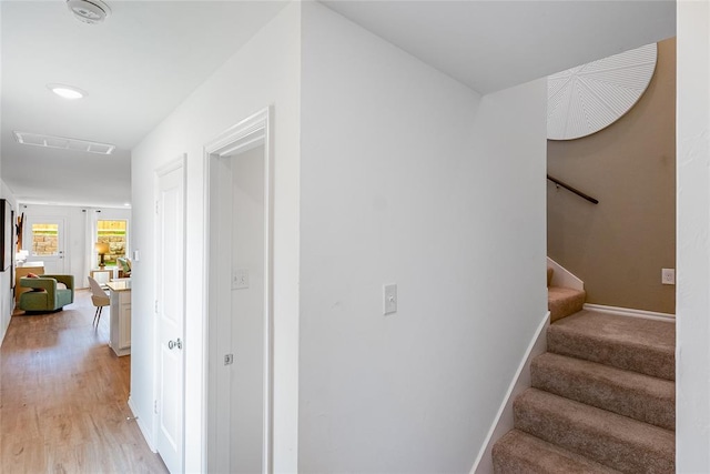 staircase with hardwood / wood-style flooring