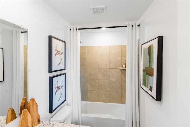 bathroom with toilet and shower / bath combo with shower curtain