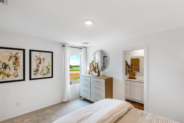 carpeted bedroom with ensuite bath