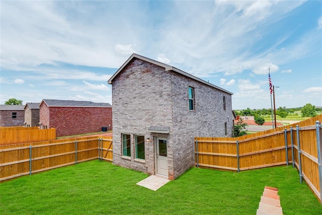 rear view of house featuring a lawn