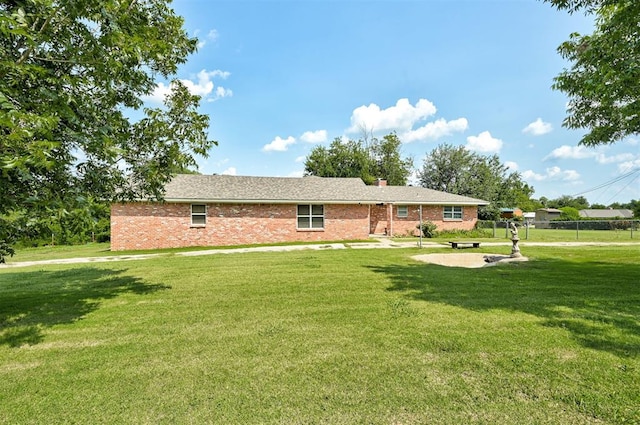 view of front facade with a front lawn and a patio