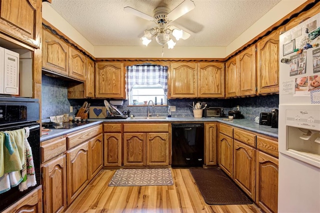 kitchen with sink, a textured ceiling, ceiling fan, light hardwood / wood-style floors, and black appliances