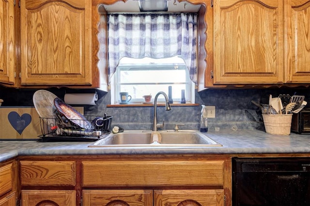 kitchen with dishwasher, sink, and backsplash