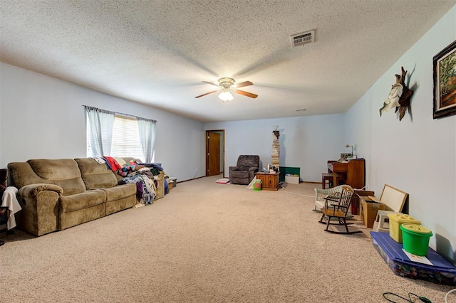 rec room with ceiling fan, carpet flooring, and a textured ceiling