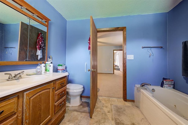 bathroom with vanity, a bath, a textured ceiling, and toilet