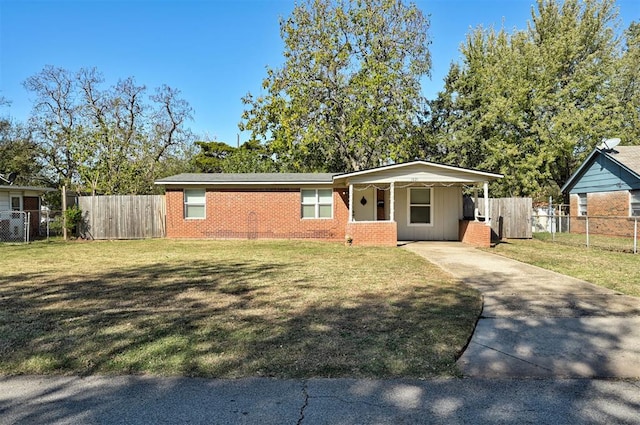 single story home featuring a carport and a front lawn