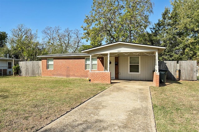 single story home with a front yard and a carport