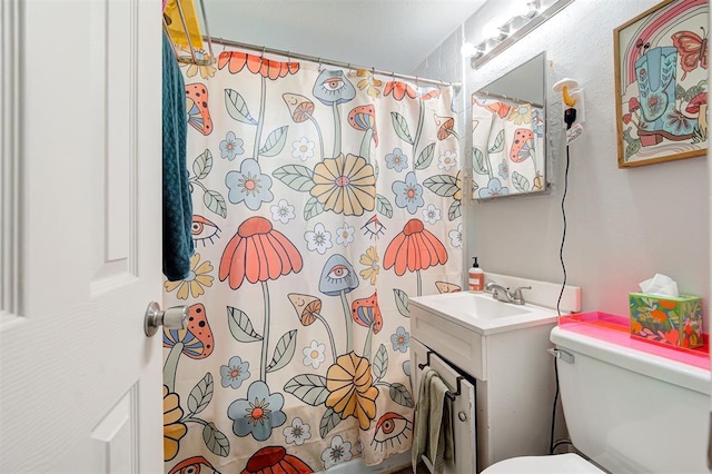 bathroom with vanity, a shower with curtain, and toilet