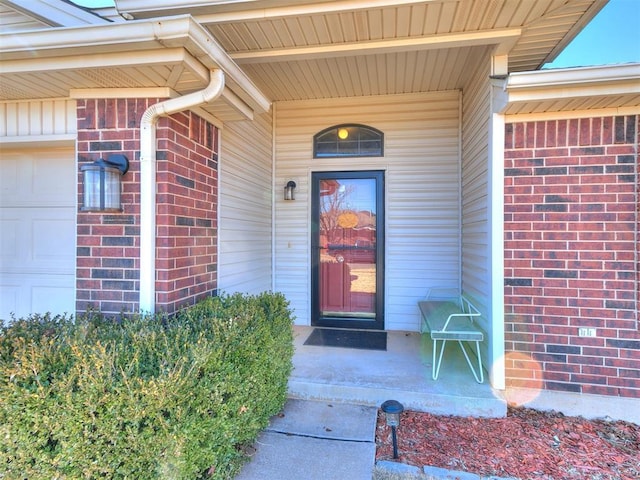 view of exterior entry featuring a garage