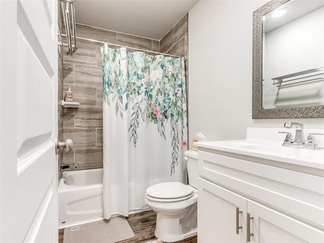 bathroom featuring toilet, wood finished floors, vanity, and shower / tub combo with curtain