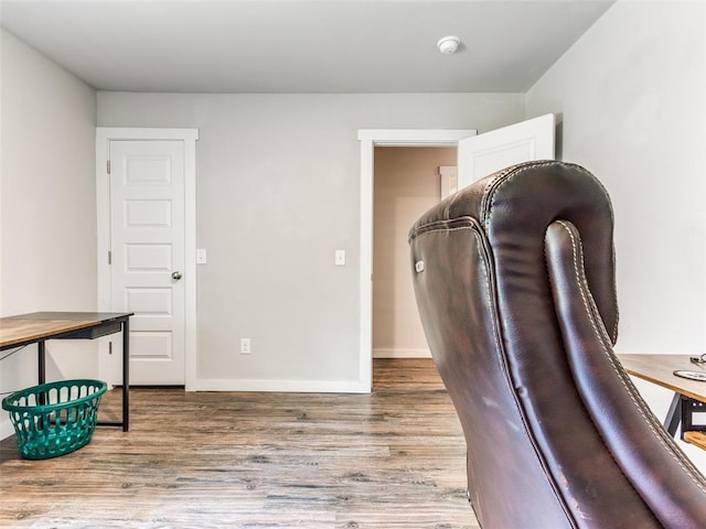 office area featuring baseboards and wood finished floors