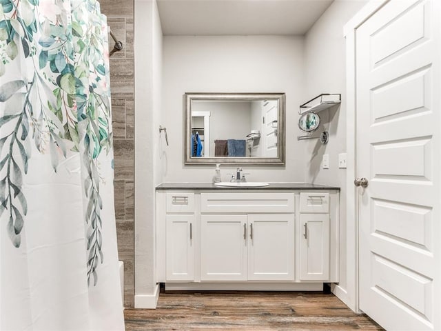 full bath with vanity, wood finished floors, and a shower with shower curtain