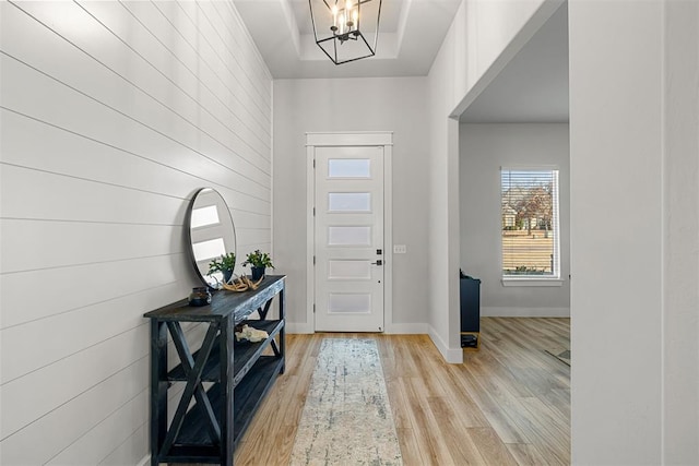 entryway with a notable chandelier and light hardwood / wood-style floors