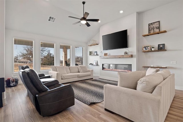 living room featuring high vaulted ceiling, ceiling fan, and light wood-type flooring