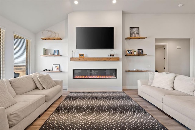 living room featuring wood-type flooring and vaulted ceiling