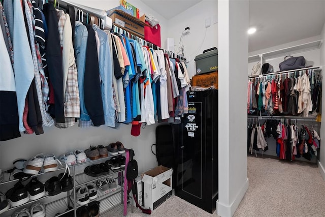 walk in closet with carpet floors