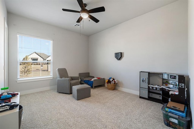 rec room with carpet floors and ceiling fan