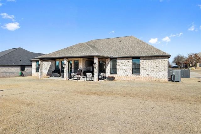 back of property with central AC and a patio area