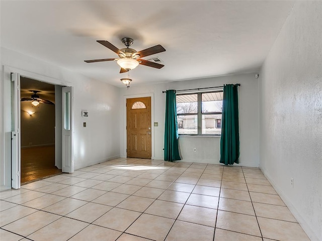 tiled foyer with ceiling fan