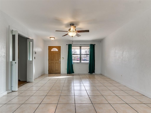 unfurnished room featuring light tile patterned floors and ceiling fan