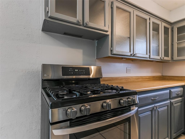 kitchen with gray cabinets and stainless steel gas stove