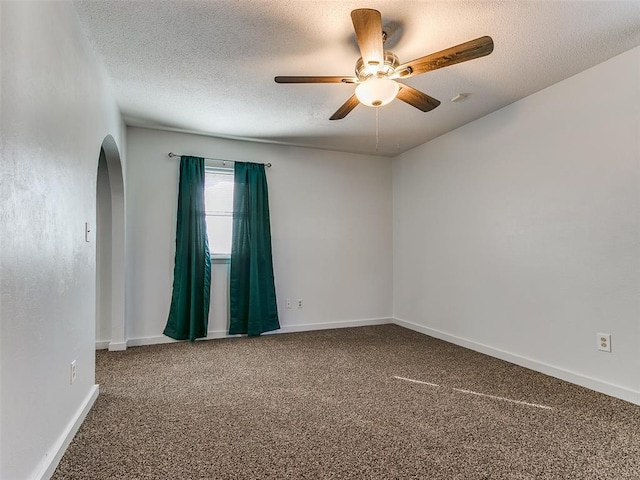 spare room with ceiling fan, carpet, and a textured ceiling