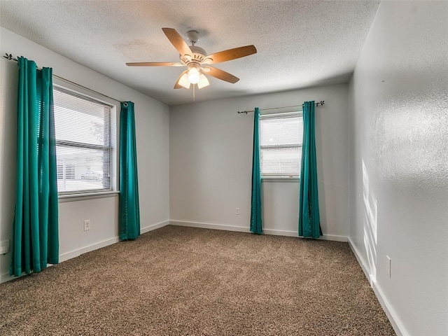 spare room featuring a textured ceiling, carpet floors, and ceiling fan