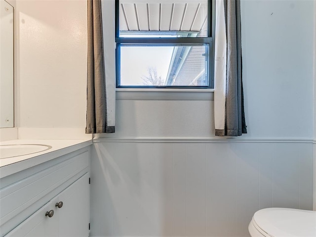 bathroom featuring vanity and toilet